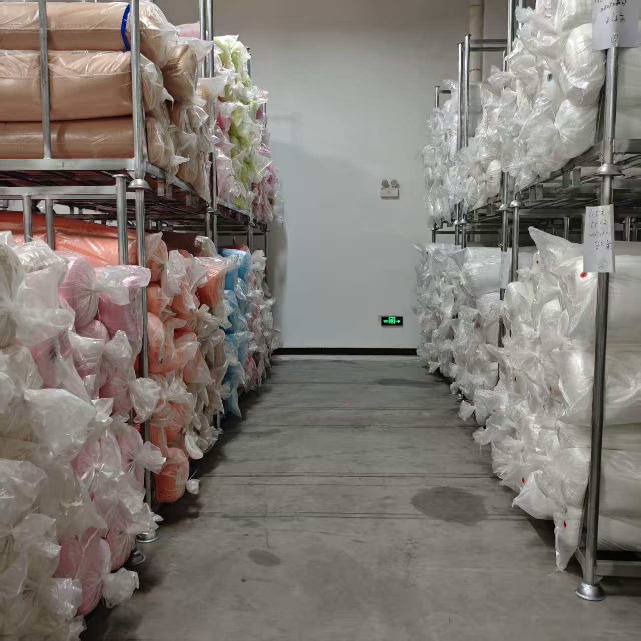Fabric rolls held along a warehouse aisle in Dongguan