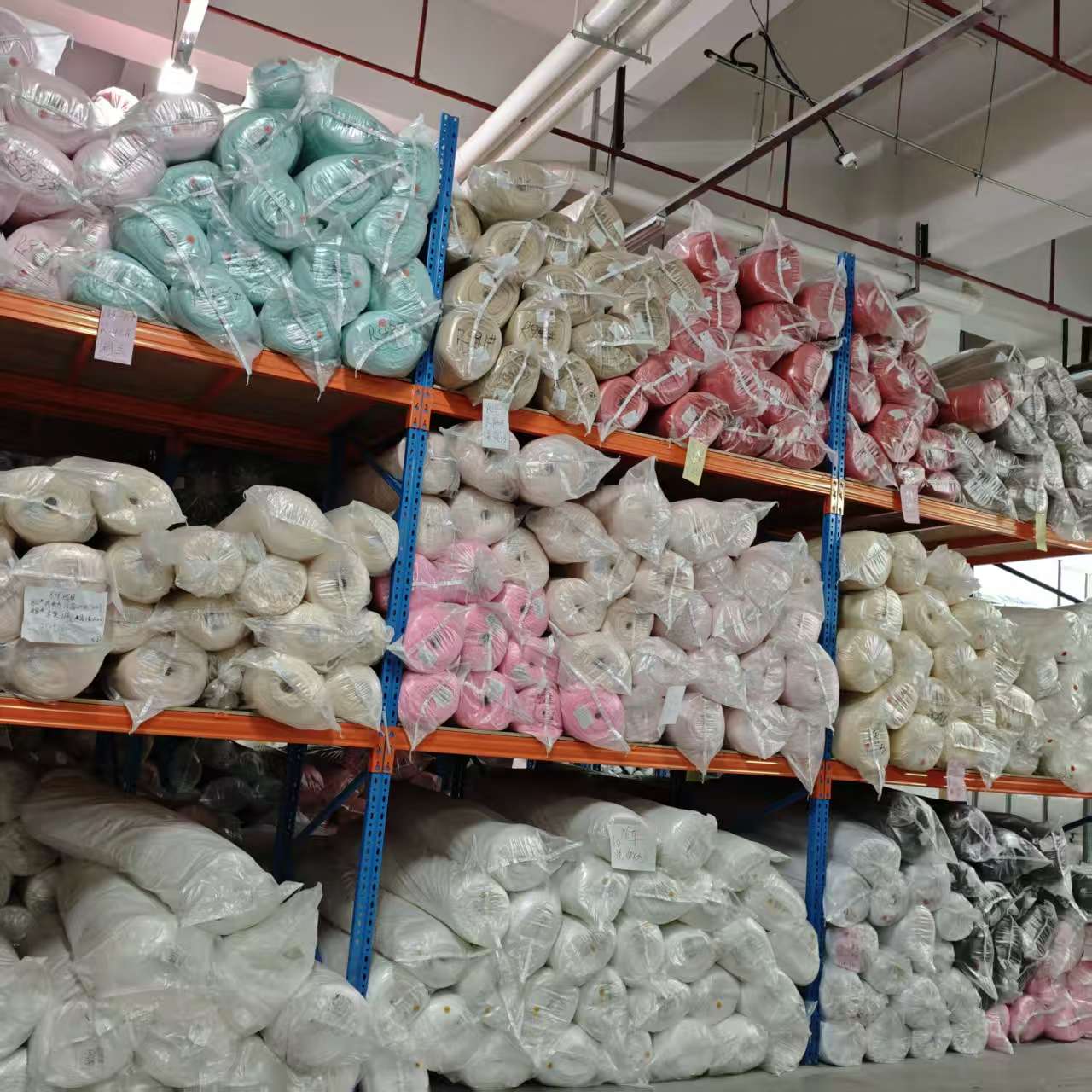 Colour fabric rolls held on warehouse racks in Dongguan